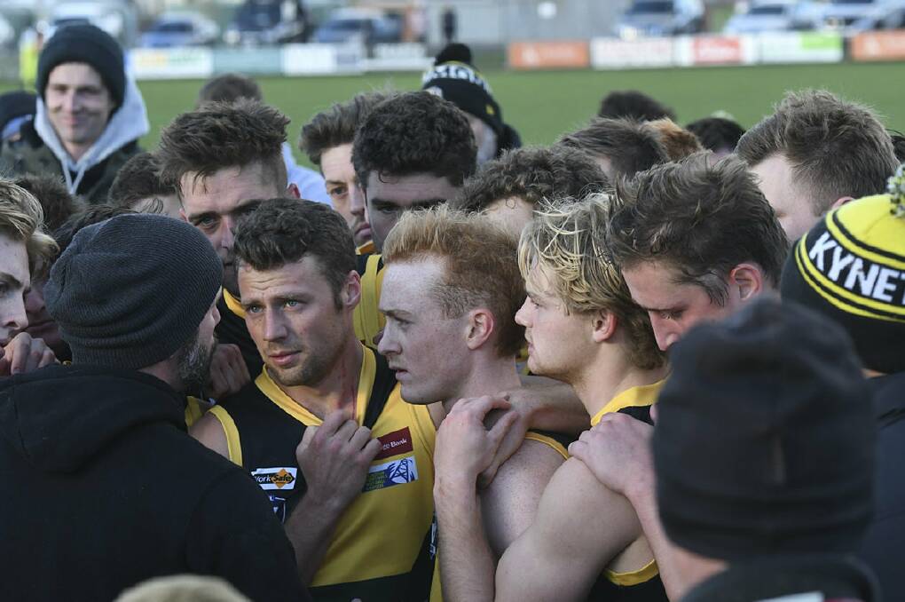 TIGER HUDDLE: Kyneton players listen to coach Paul Chapman during a quarter-time break this year. The Tigers have cleared their $200,000 debt revealed in August of 2018.