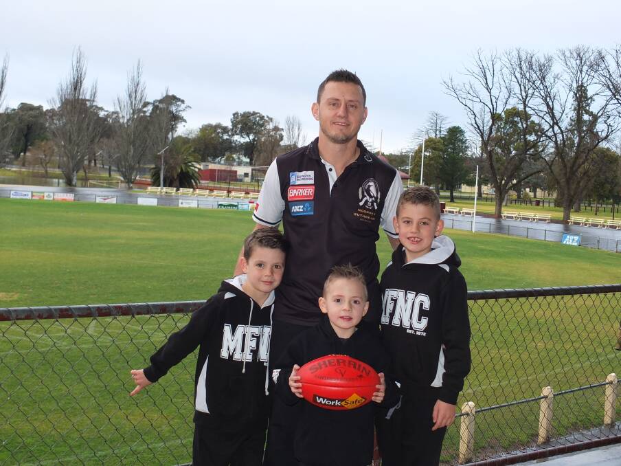 FAMILY MAN: Cameron Skinner with three of his biggest supporters - sons Billy, Max and Jack ahead of his 300th game for Maryborough on Saturday. Picture: CONTRIBUTED