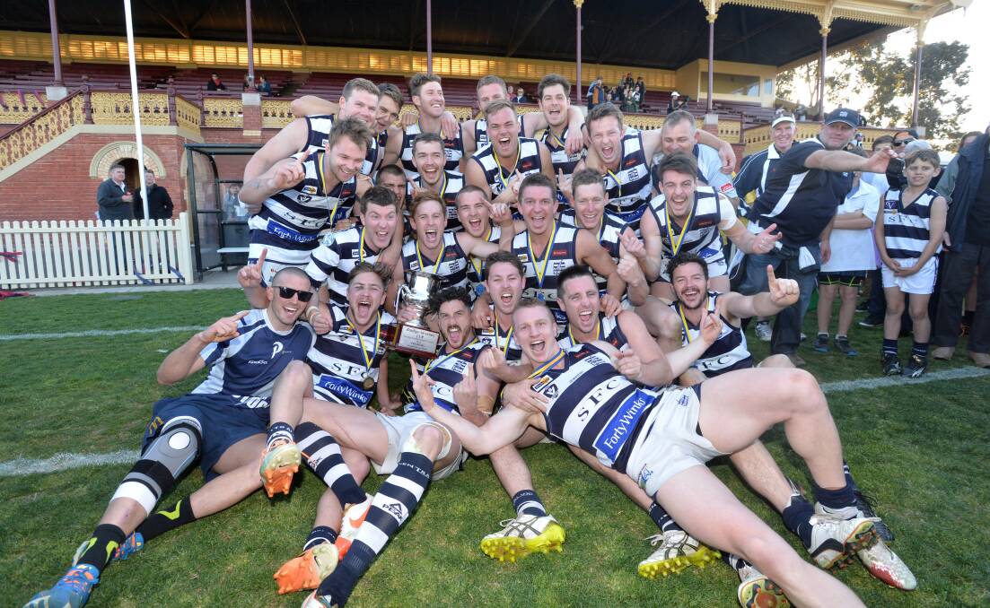 HISTORY-MAKERS: The Strathfieldsaye team of 2014 that won the Storm's first BFNL premiership by beating Sandhurst in the grand final.