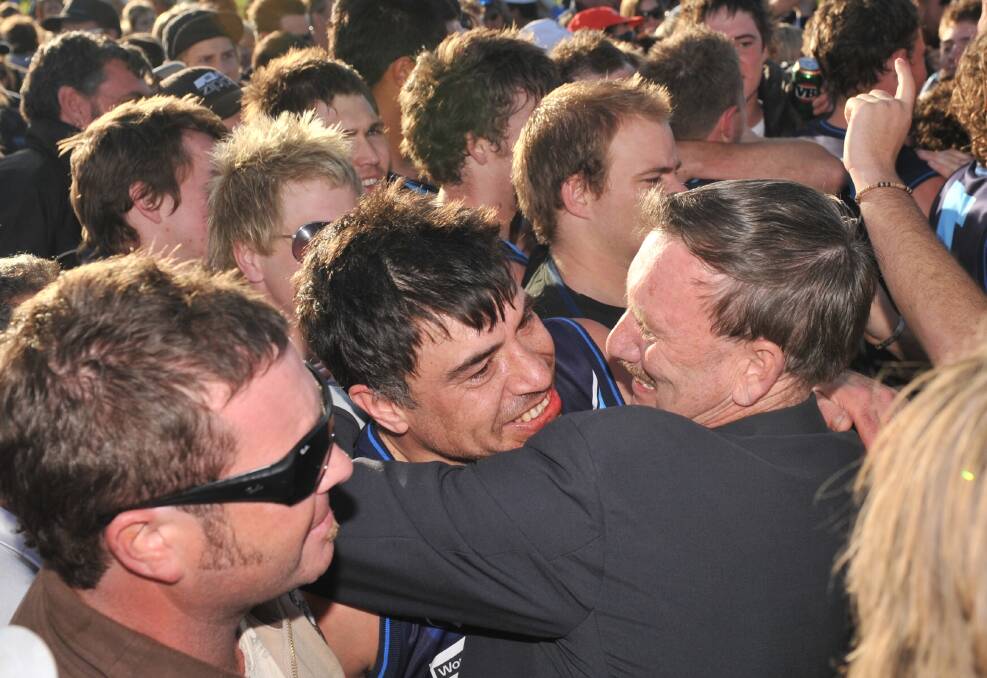 JOB WELL DONE: Eaglehawk coach Derrick Filo with president Ray McLean in the middle of the celebrations.