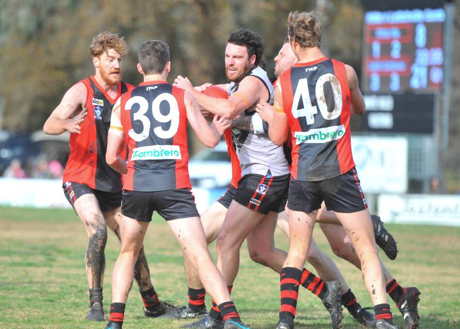 SURROUNDED: Leitchville-Gunbower's Bart Walsh is caught in a cluster of White Hills players on Saturday. The Bombers defeated the Demons by 29 points at White Hills. Picture: ADAM BOURKE
