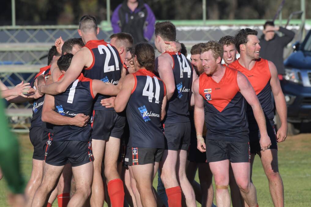 FLAG SUCCESS: Wycheproof-Narraport players celebrate their 2018 premiership. The Demons have been an NCFL force since Wycheproof and Narraport merged in 1964.