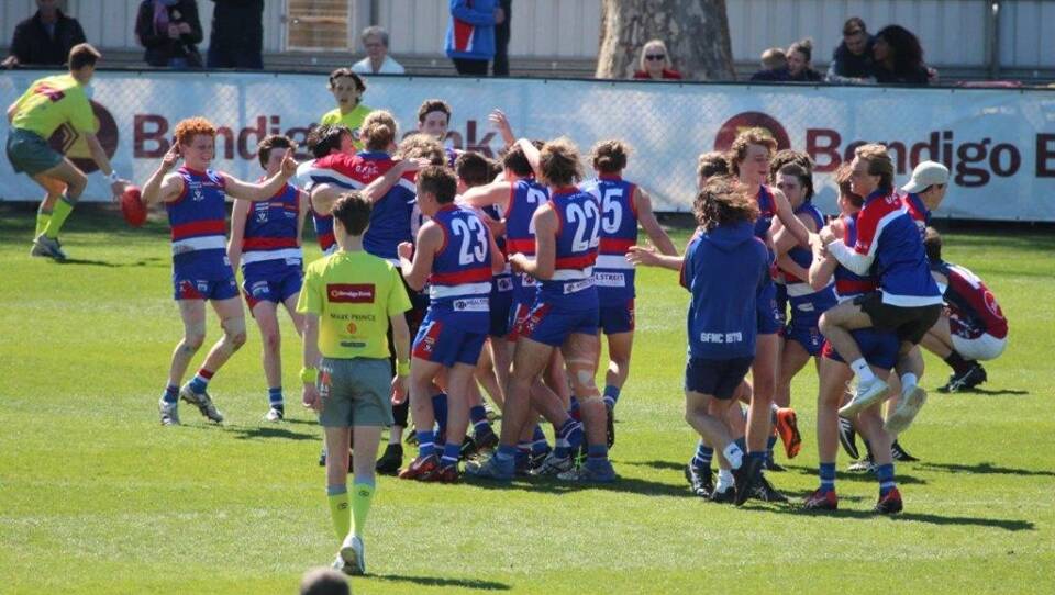 Gisborne's under-18s celebrate last year's flag. Nathan Williams is pictured on the right jumping on the back of one of his team-mates.