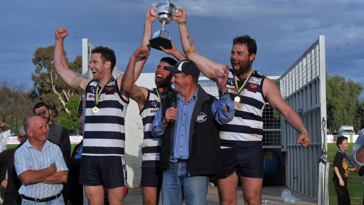 FAMILIAR FACES: Co-captain Nathan O'Brien (left) and coach Kahl Oliver (right) hold aloft the HDFL premeirship cup in 2013.