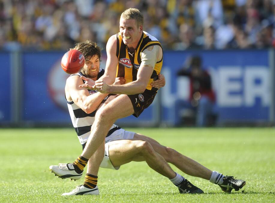 HOT CONTEST: Rick Ladson is tackled by Geelong's Max Rooke. Playing in defence, Ladson had 14 disposals and kicked a goal in the 2008 grand final.