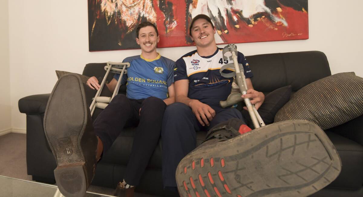 SIDELINED: Brothers Nathan and Will Holt are both walking with crutches after suffering injuries within seven days of each other. Nathan's season is over for Golden Square, while Will is hoping to return later this year for the Bendigo Pioneers. Picture: NONI HYETT