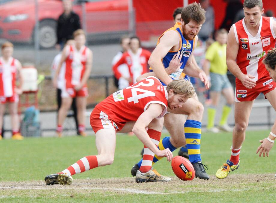 CENTRE BATTLE: South Bendigo ruckman Adrian Coad and Golden Square counterpart Matt Compston tussle during Saturday's BFNL clash at the QEO. Golden Square won by 38 points after leading by as many as 63. Pictures: DARREN HOWE