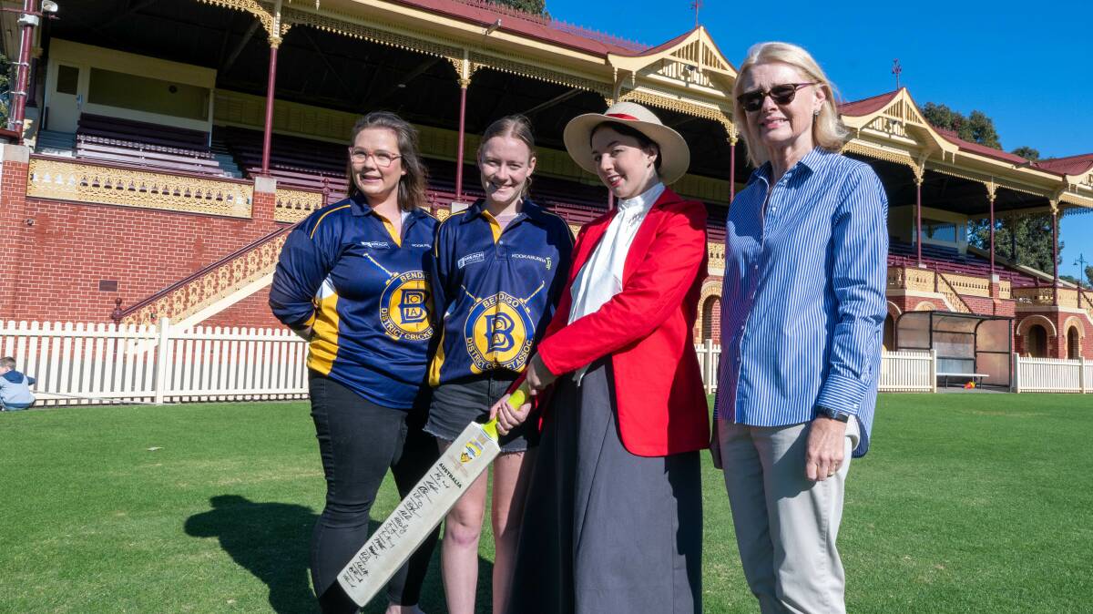 Bendigo players Karmel McClure and Letesha Bawden with Aimee Parry wearing a replica of a women's cricket outfit from the 19th century and Diane Robertson. Picture by Enzo Tomasiello