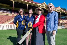 Bendigo players Karmel McClure and Letesha Bawden with Aimee Parry wearing a replica of a women's cricket outfit from the 19th century and Diane Robertson. Picture by Enzo Tomasiello