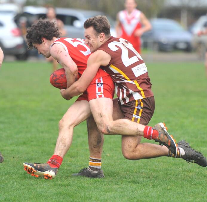 GOTCHA: Huntly's Mitchell Edwards tackles Elmore's Matthew Nettlefold during the third quarter of Saturday's clash won by the Hawks by 46 points.