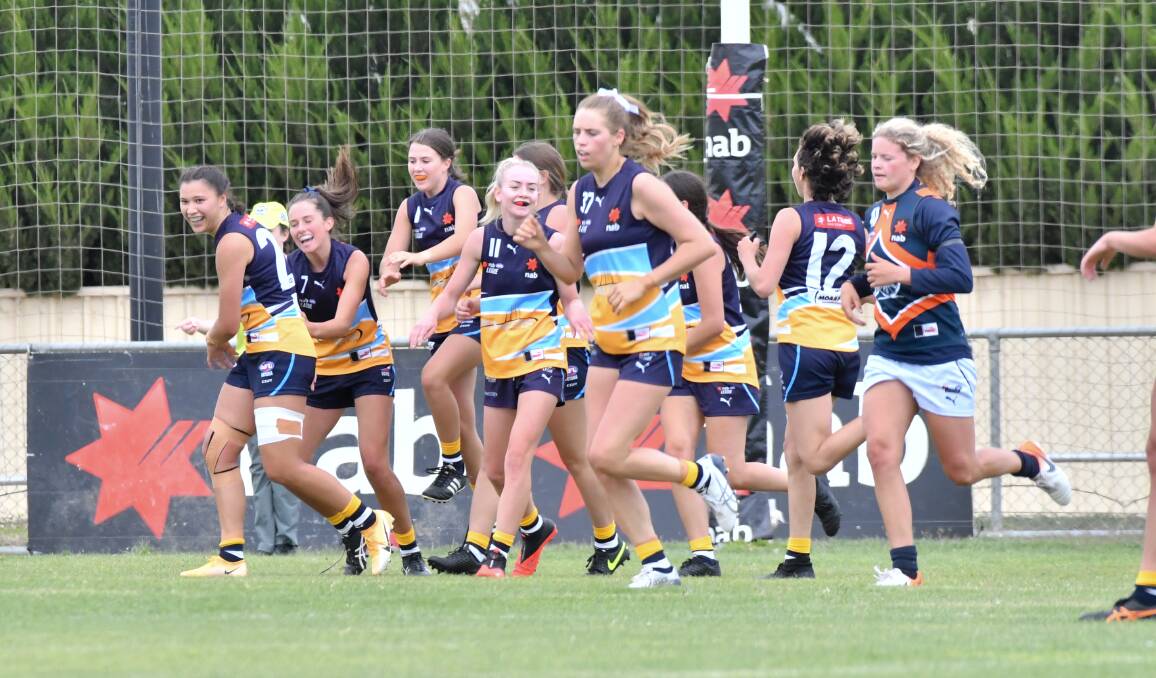 THROUGH THE BIG STICKS: The Bendigo Pioneers girls celebrate one of their three goals on Saturday against the Calder Cannons at Epsom-Huntly Recreation Reserve in round four of the NAB League. Picture: NONI HYETT