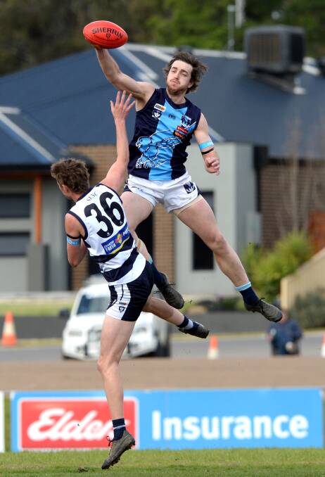 TAP: Eaglehawk's Clayton Holmes wins this ruck duel against Strathfieldsaye's Lachlan Monti at Tannery Lane on Saturday. Pictures: DARREN HOWE