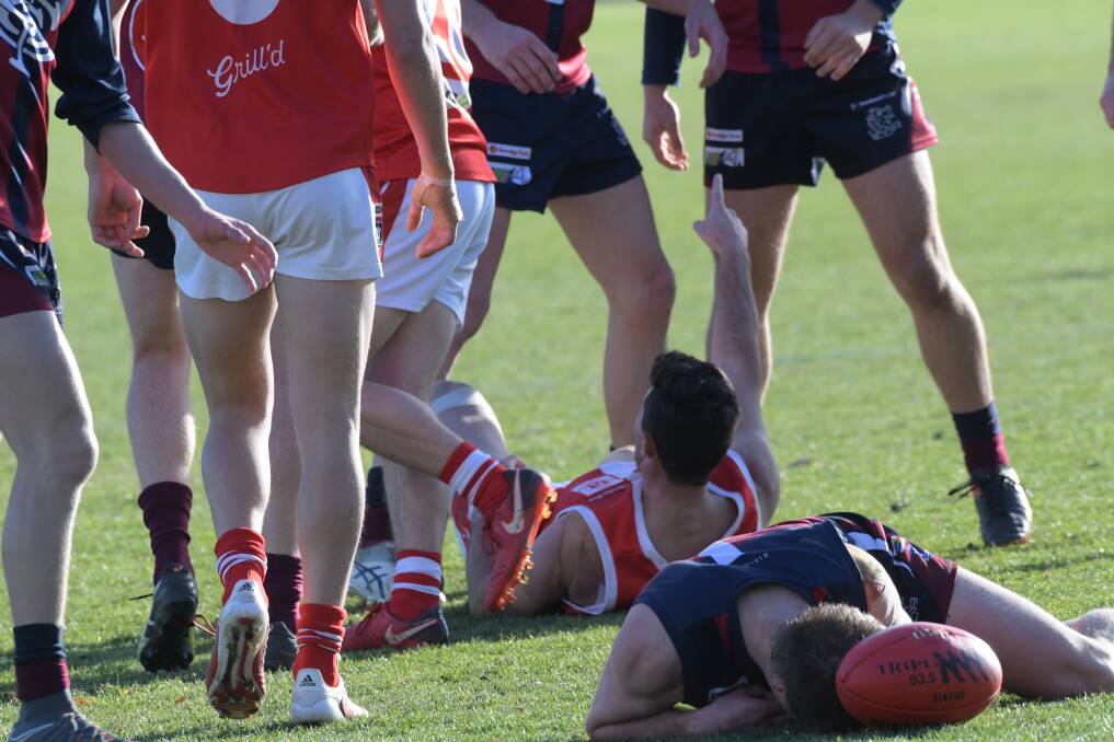 Sandhurst's Lee Coghlan is concussed on the ground. Picture: NONI HYETT