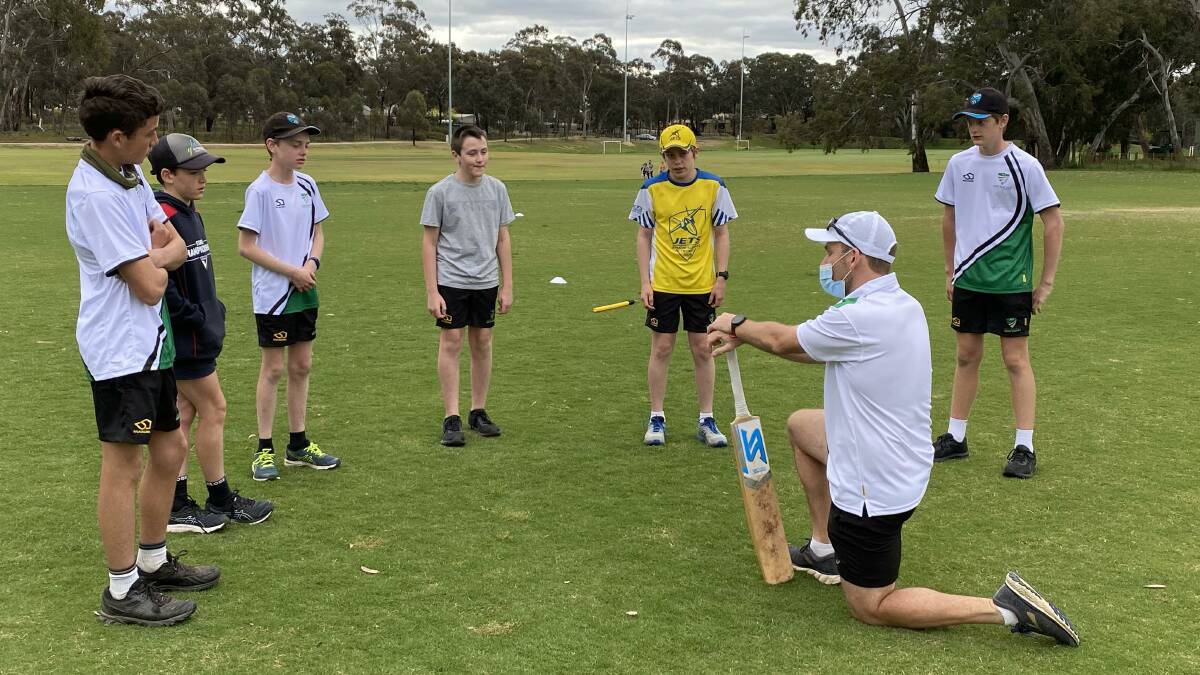 NEXT LEVEL: Players listen to coach Grant Waldron at this week's academy session at Strathdale's Bell oval.