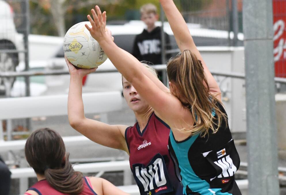PASS: Sandhurst's Emma Tindal looks to dish off to a team-mate.