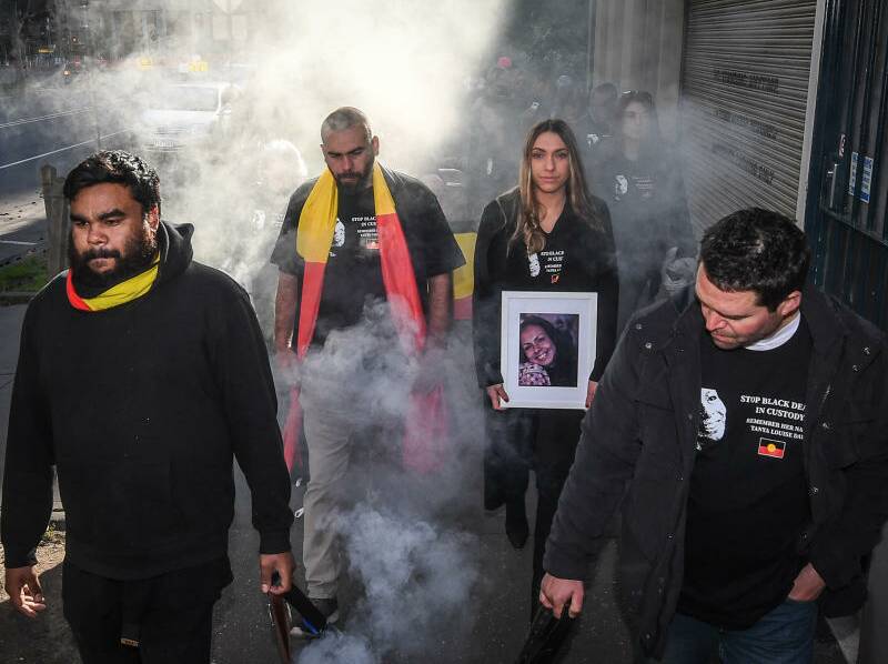 Tanya Day's family and supporters being smoked on their walk from Kings Domain to the Coroners court. Photo: Justin McManus