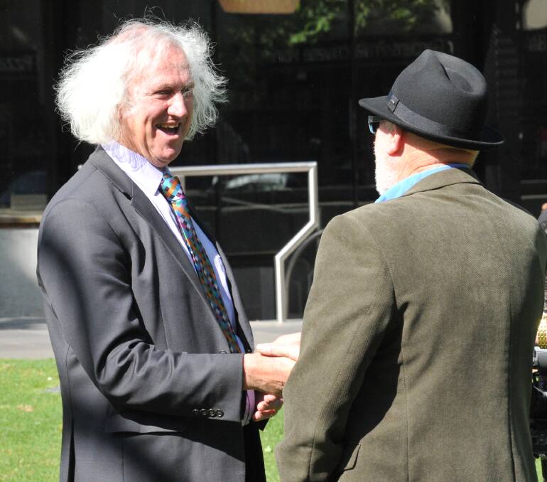 CHANGING OF GUARD: Mayor-elect Rod Fyffe [left] shakes hands with outgoing Mayor Peter Cox after the former was endorsed by his colleagues to take the city's top job last month. Picture: JOSEPH HINCHLIFFE
