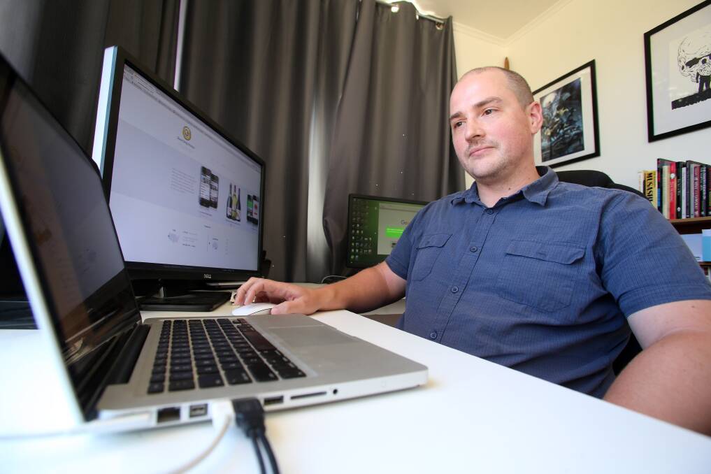WORK LIFE BALANCE: Damien Mason in his office at home – slow internet speeds mean the web developer needs to make up for time lost waiting for downloads . Picture: GLENN DANIELS