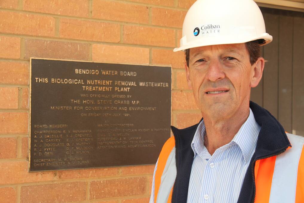 Neil Burns, chief engineer on the Bendigo Water Reclamation Plant project, beside the plaque for its official opening.

