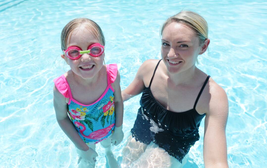 STAY SAFE: Alicia Bergin giving her six-year-old-daughter Sienna swimming lessons – the state government is urging vigilance with children and water this summer. Picture: DARREN HOWE