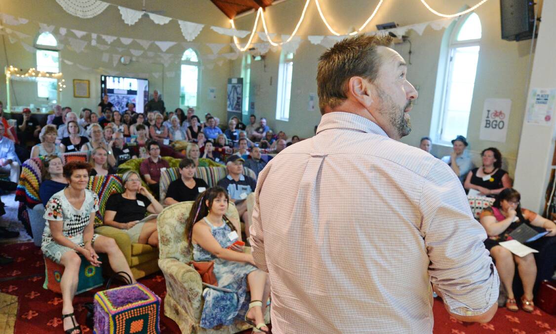 PLACE SETTERS: The city's Phil DeAraugo addresses a crowd of more than one hundred which crammed into old church on Quarry Hill. Picture: DARREN HOWE