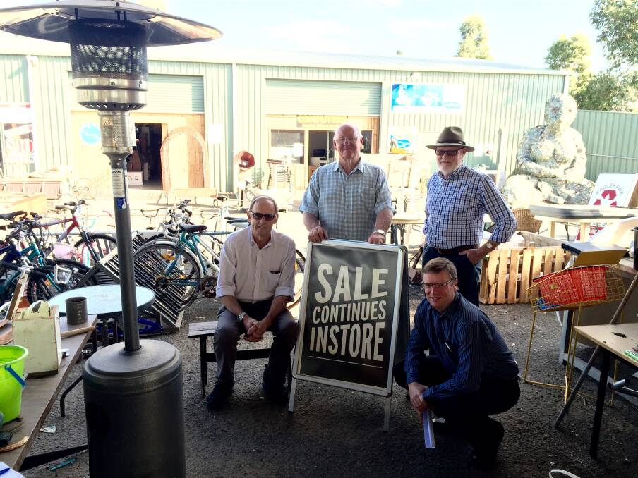 SALES CONTINUE: Eaglehawk Recycle Shop vice president Rod Hanson, president Leon Scott, secretary and councillor Peter Cox and the city's acting presentation and assets director Brett Martini in front of a sign sold this morning at the recycle shop. Picture: JOSEPH HINCHLIFFE
