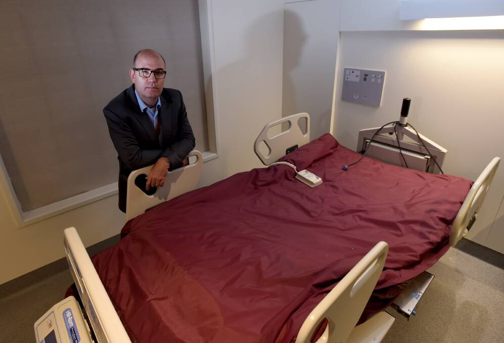 
EXPANSION: Bendigo Health director of medicine Dr Mark Savage pictured with a bariatric bed. Picture: JODIE WIEGARD
