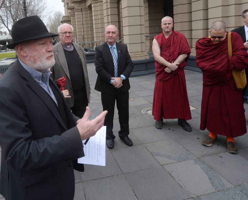 TAKING A STAND: Bendigo Mayor Peter Cox addresses community leaders outside Town Hall. Picture: DARREN HOWE