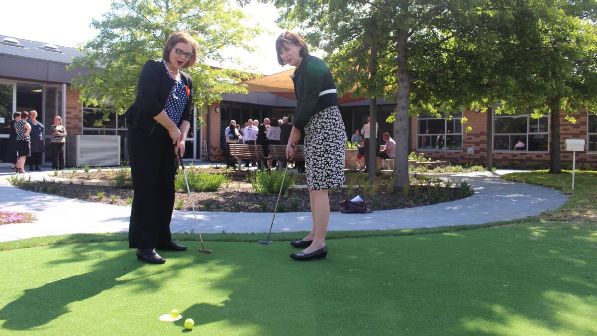 ON TARGET: Bendigo MP Lisa Chesters and Macedon Ranges MP Mary-Anne Thomas test their skills on the putt-putt green at the new $7.4 million care facility at Kyneton Hospital.