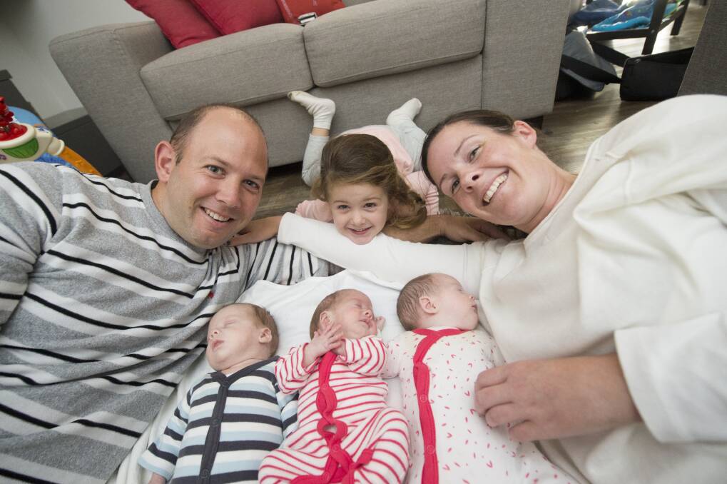 HAPPY FAMILY: Matthew, Alexys and Karen Higgins with the triplets Jamison, Matisse and Aubrey Higgins. Picture: DARREN HOWE