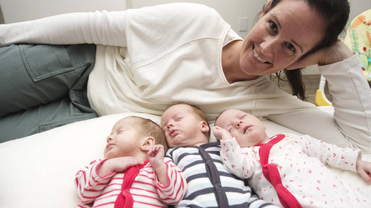 PLEASANT SURPRISE: Karen Higgins dotes on her triplets Matisse, Jamison and Aubrey, who were born prematurely in February. Picture: DARREN HOWE