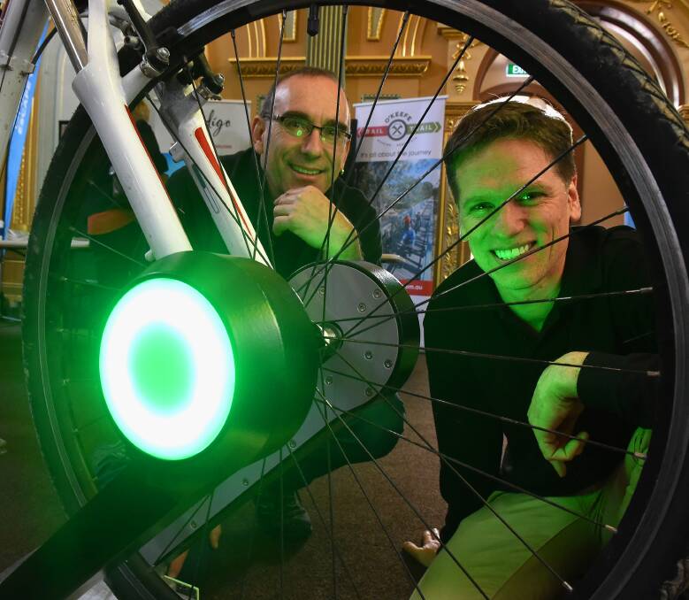 JOY RIDE: Woodend-based Phil Aarons and Al Reid demonstrate their CyclePort system, which is a technology that allows bicycles to be shared. Picture NONI HYETT