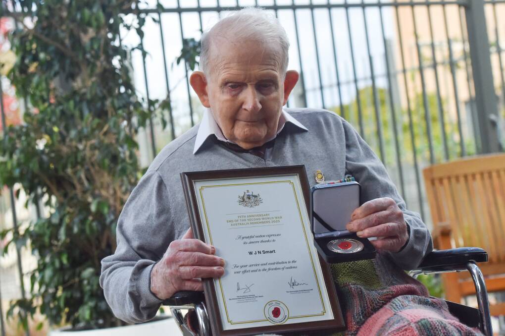 PRESENTATION: Norm Smart with his medallion and certificate, presented during an Anzac service yesterday. Picture: DARREN HOWE