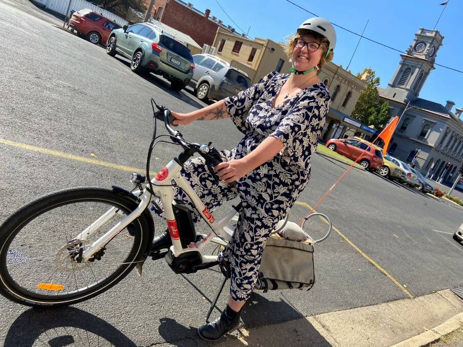 FIGHTING POLLUTION: Councillor Rosie Annear tries out an electric bicycle. Picture: SUPPLIED