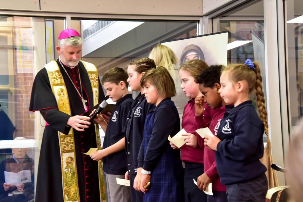 BIG OCCASION: Bishop Shane MacKinlay with St Liborius Primary School students at Thursday morning's ceremony. Picture: BRENDAN McCARTHY 