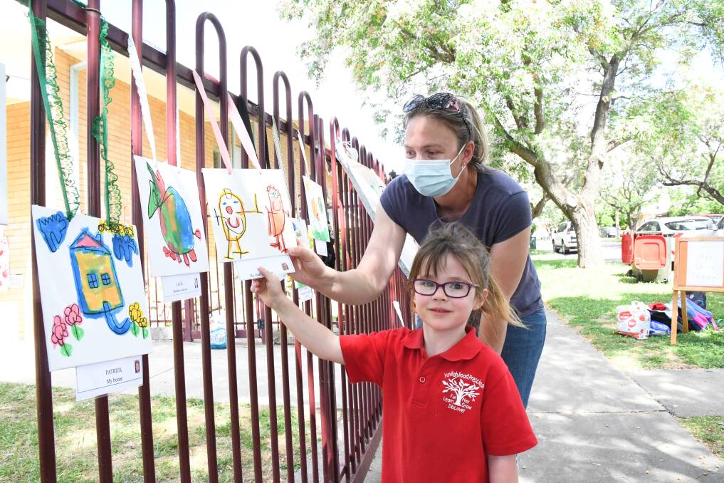 ART ATTACK: Havilah Road Preschool's Mia Jenkins showed off her best work to mum Christine on Tuesday. Picture: NONI HYETT
