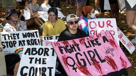 Signs are held during an abortion rights rally on the grounds of the Alabama Archives building followed by a march on to Alabama state capitol building in Montgomery, Ala. Photo: Mickey Welsh-USA TODAY NETWORK/Sipa USA /AAP Image