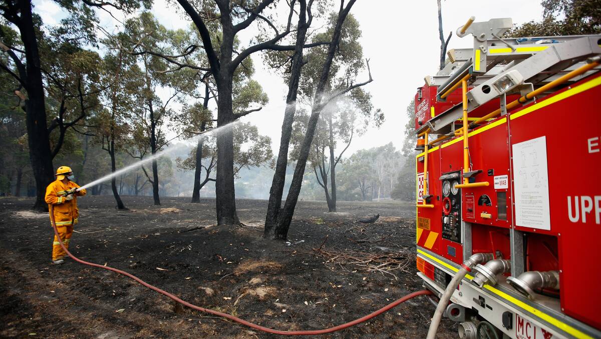 CFA firefighters contain one side of a fire in Wandin on December 19. Picture: DARRIAN TRAYNOR