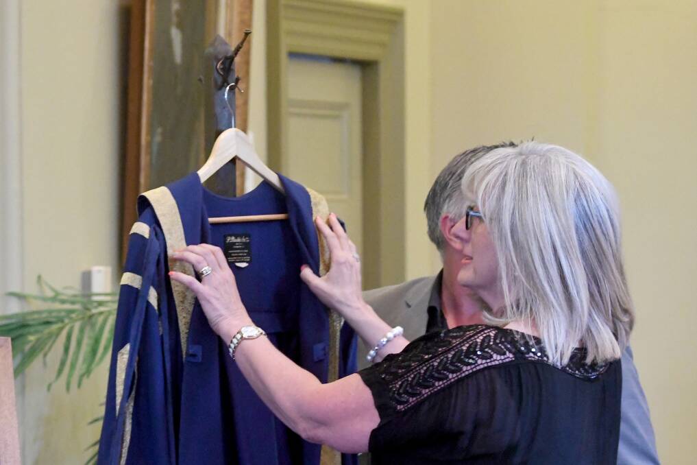 Councillor Margaret O'Rouke prepares to don the mayoral robes after being selected to lead her colleagues in 2017. Picture: DARREN HOWE
