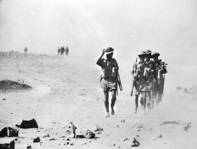 Australian soldiers march out to the front line, across hard, flat country that enemy soldiers could watch and shell. Picture: GEORGE SILK courtesy of the AUSTRALIAN WAR MEMORIAL