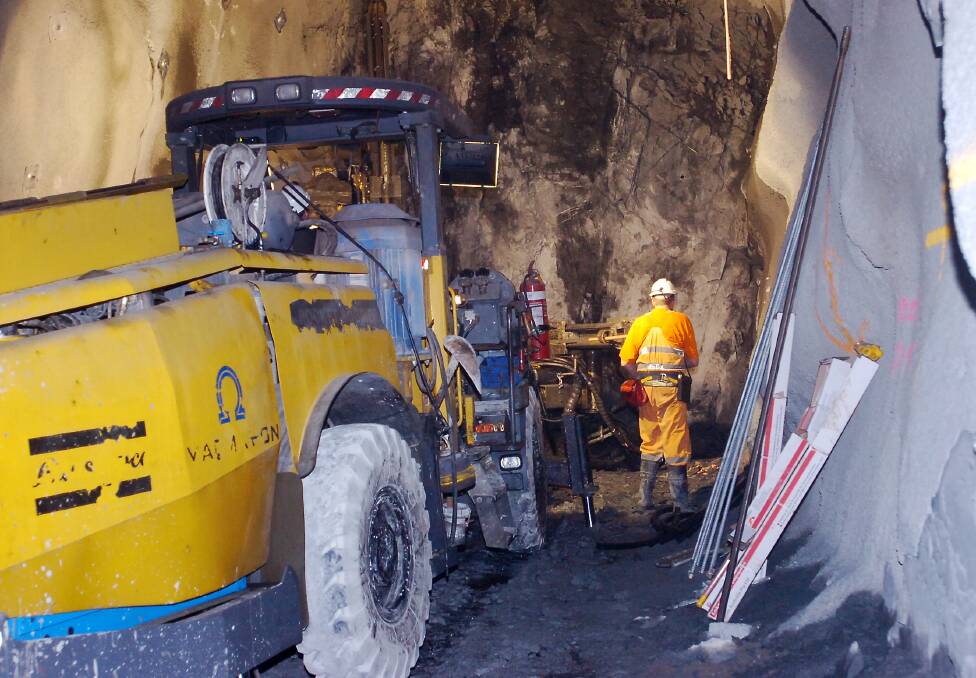 Miners use a drilling machine to cut through rock deep under Bendigo in 2005. Picture: LAURA SCOTT
