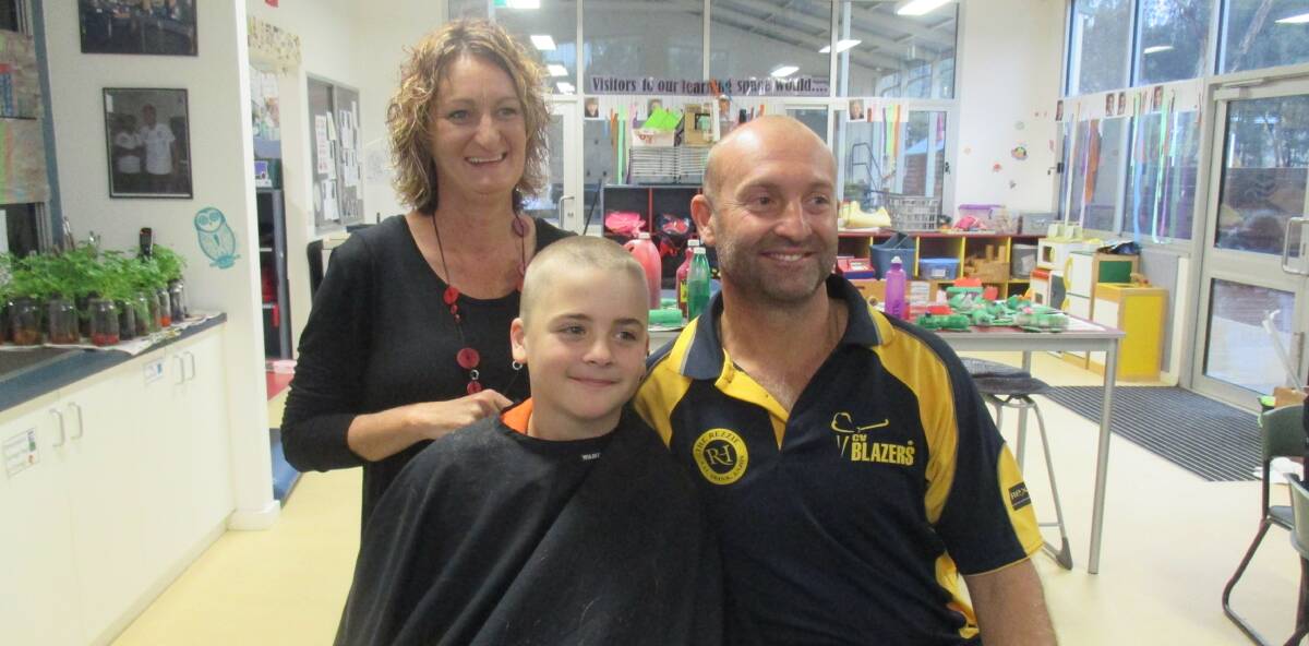 LIKE FATHER, LIKE SON: Declan and Greg Anderson pose for pictures after hairdresser Mandy Carslake finishes her work. Picture: CONTRIBUTED