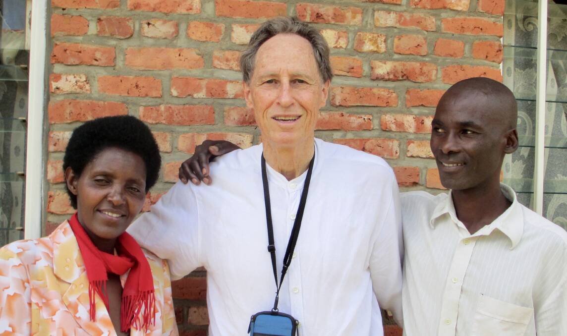 RECONCILED: John Steward (centre) with a survivor of the Rwandan Genocide and her attacker, who cut of her hand and left her for dead. Picture: SUPPLIED