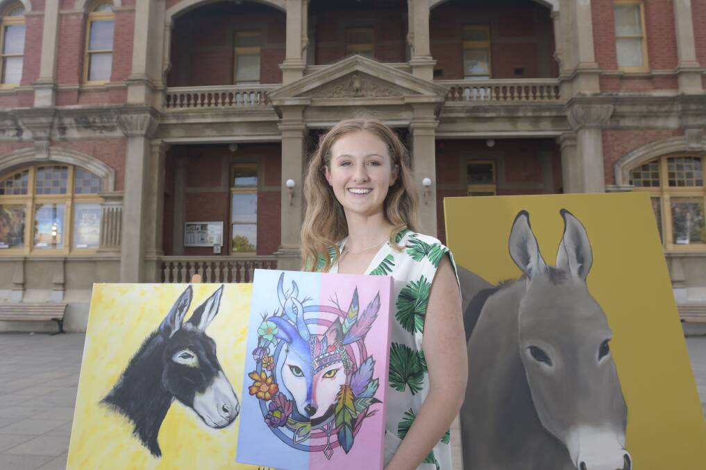 SHOWCASED: Allira Walker with the works that won her recognition through the Eaglehawk Dahlia and Arts Festival, which was launched Wednesday night at the Star Cinema. Picture: NONI HYETT