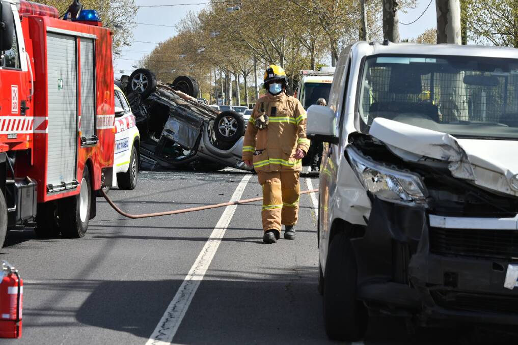 A firefighter at the scene of the crash. Picture: NONI HYETT