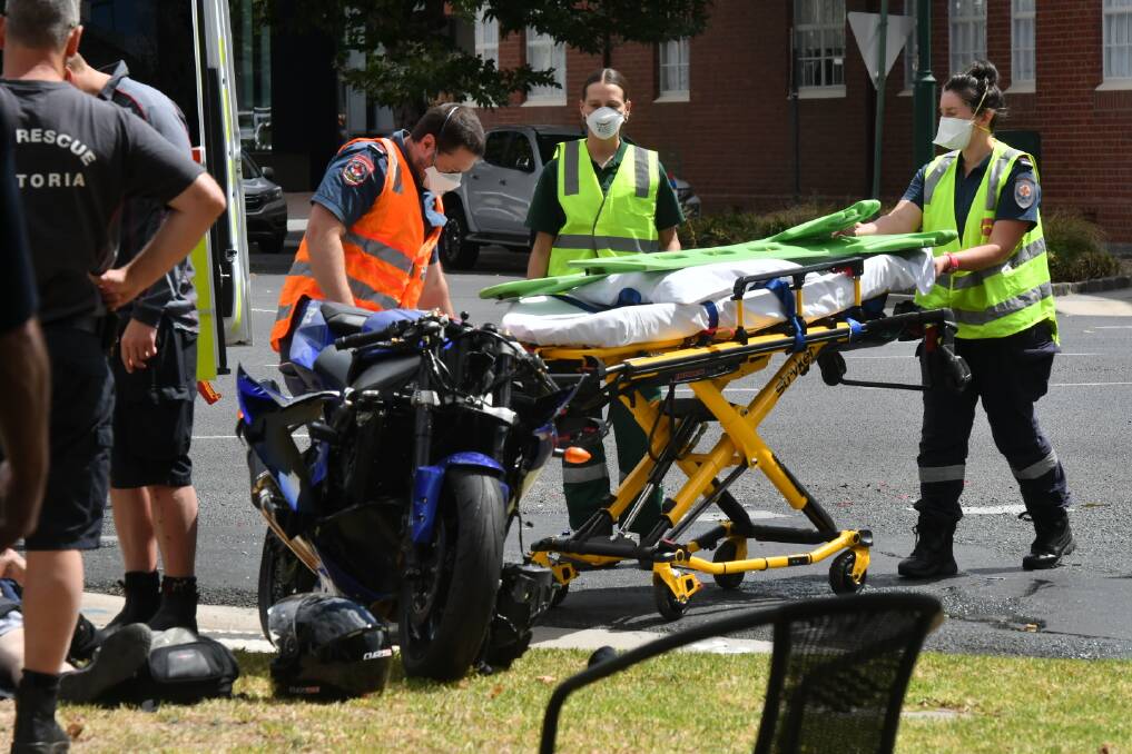 Paramedics work at the scene of a crash in Bendigo. Picture: NONI HYETT
