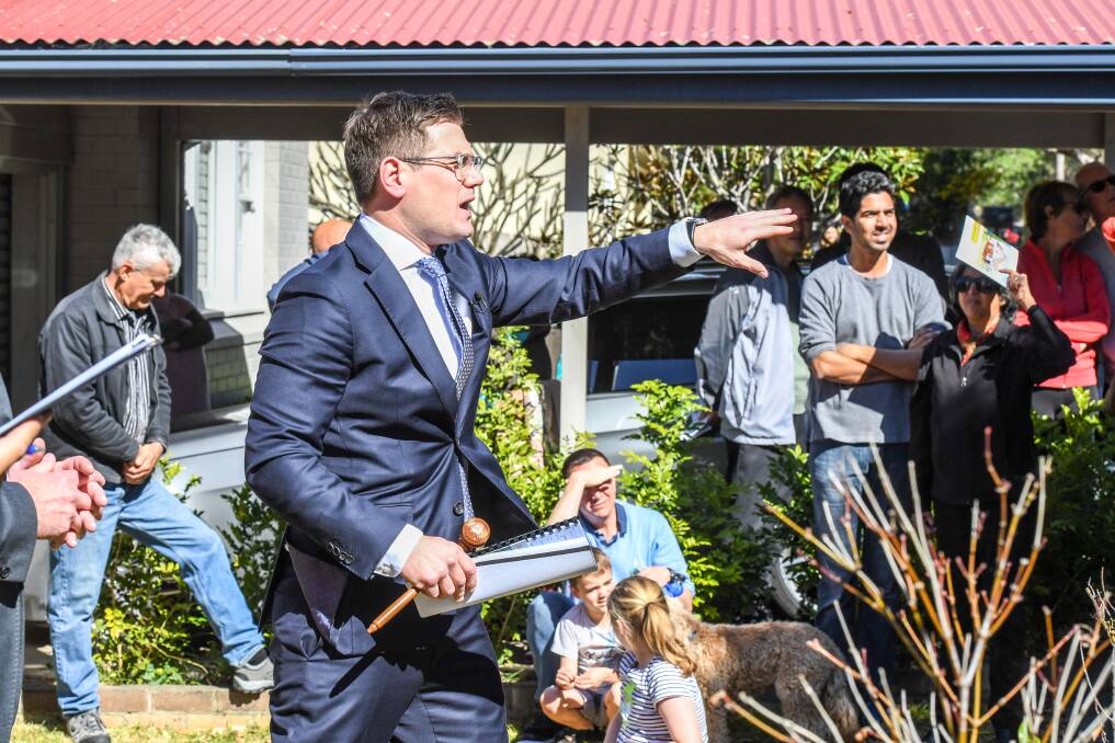 Auctioneer Jesse Davidson over the weekend in Sydney, where the housing market is declining in value. Photo: Peter Rae