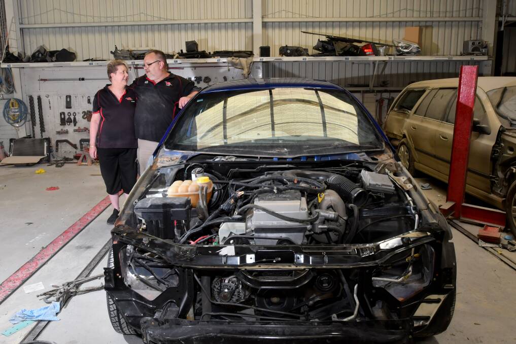 Nikki and Dean Rundle with one of the last cars to be fixed at BTB Accident Repair. Picture: NONI HYETT