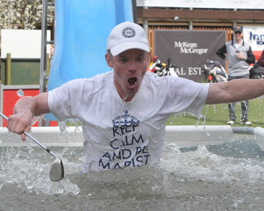 Marist College principal Darren McGregor takes the plunge at last year's Big Freeze golf day. Picture: NONI HYETT