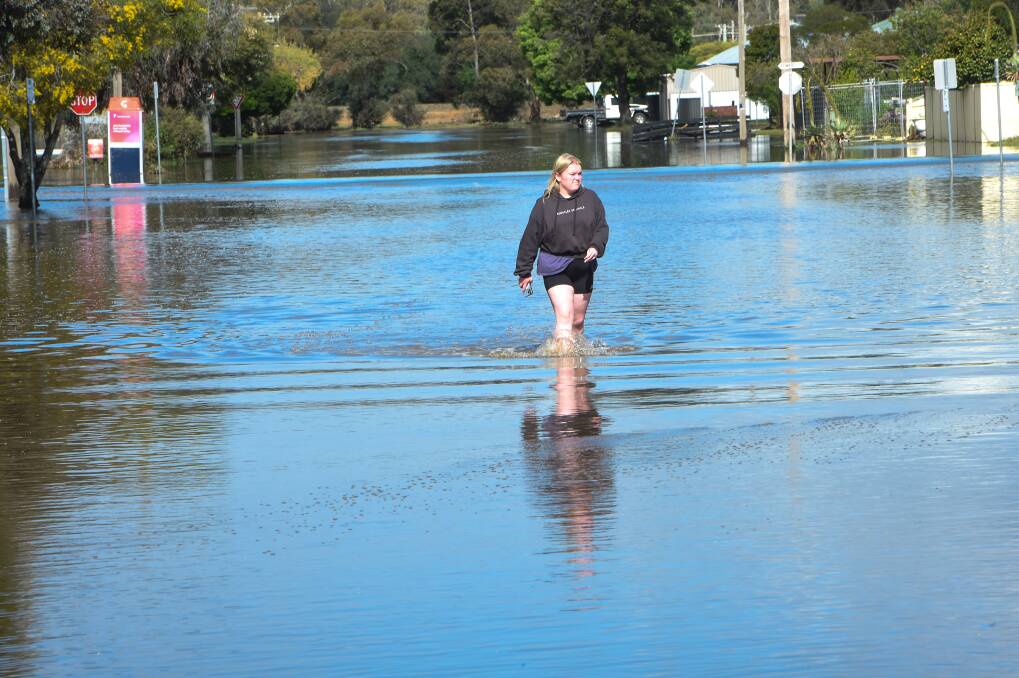 Georgia Waters goes to inspect her nan's house after it was hit by flooding. Picture by Darren Howe.